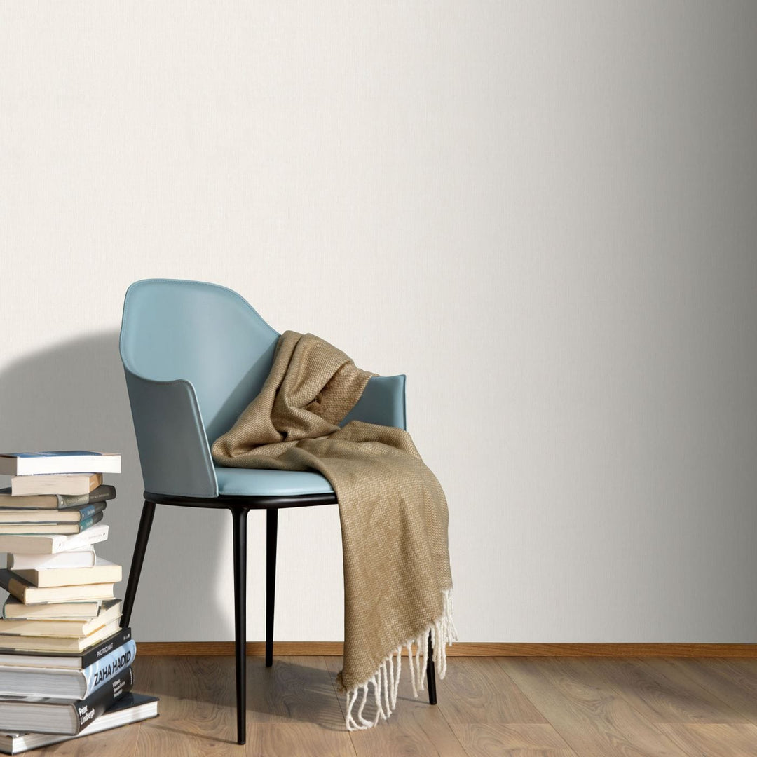 Modern room interior with light cream background wallpaper by a blue lounge chair 12186-26