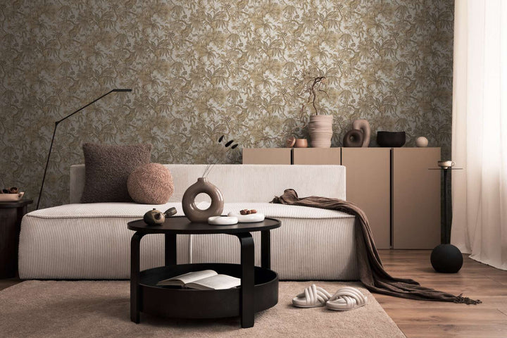 Beige botanical pattern wallpaper in a living room interior with a light striped sofa and brown wood plank flooring with a soft rug