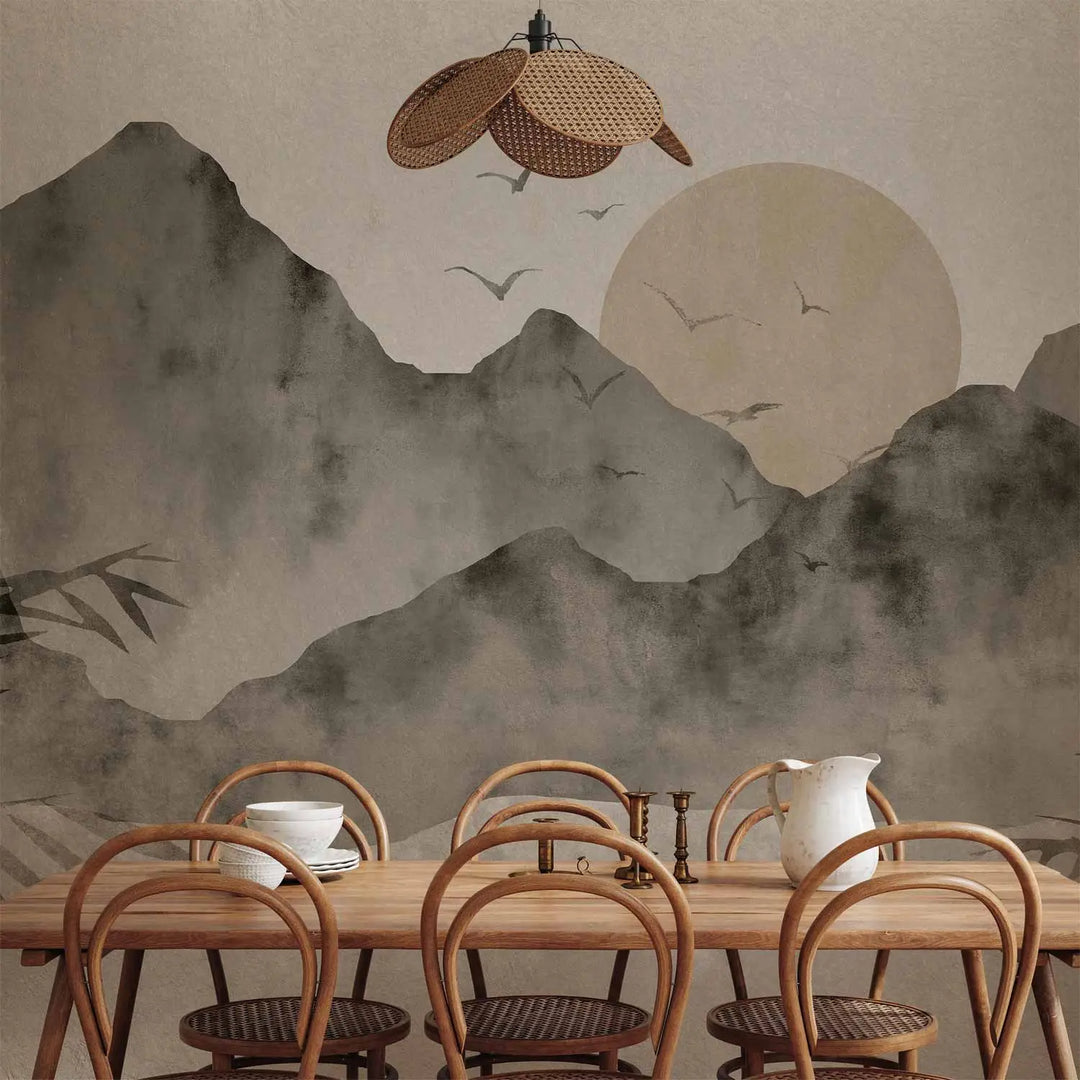 Photo wallpaper with a watercolor mountain landscape in cool tones in a dining room interior behind a wooden table with chairs and a wicker ceiling lamp