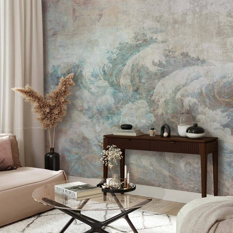 Artistic photo wallpaper with an aged, weathered gray and sand-colored plaster texture, featuring a partially faded, classic ocean wave motif in blue and white tones, imitating an ancient fresco.
