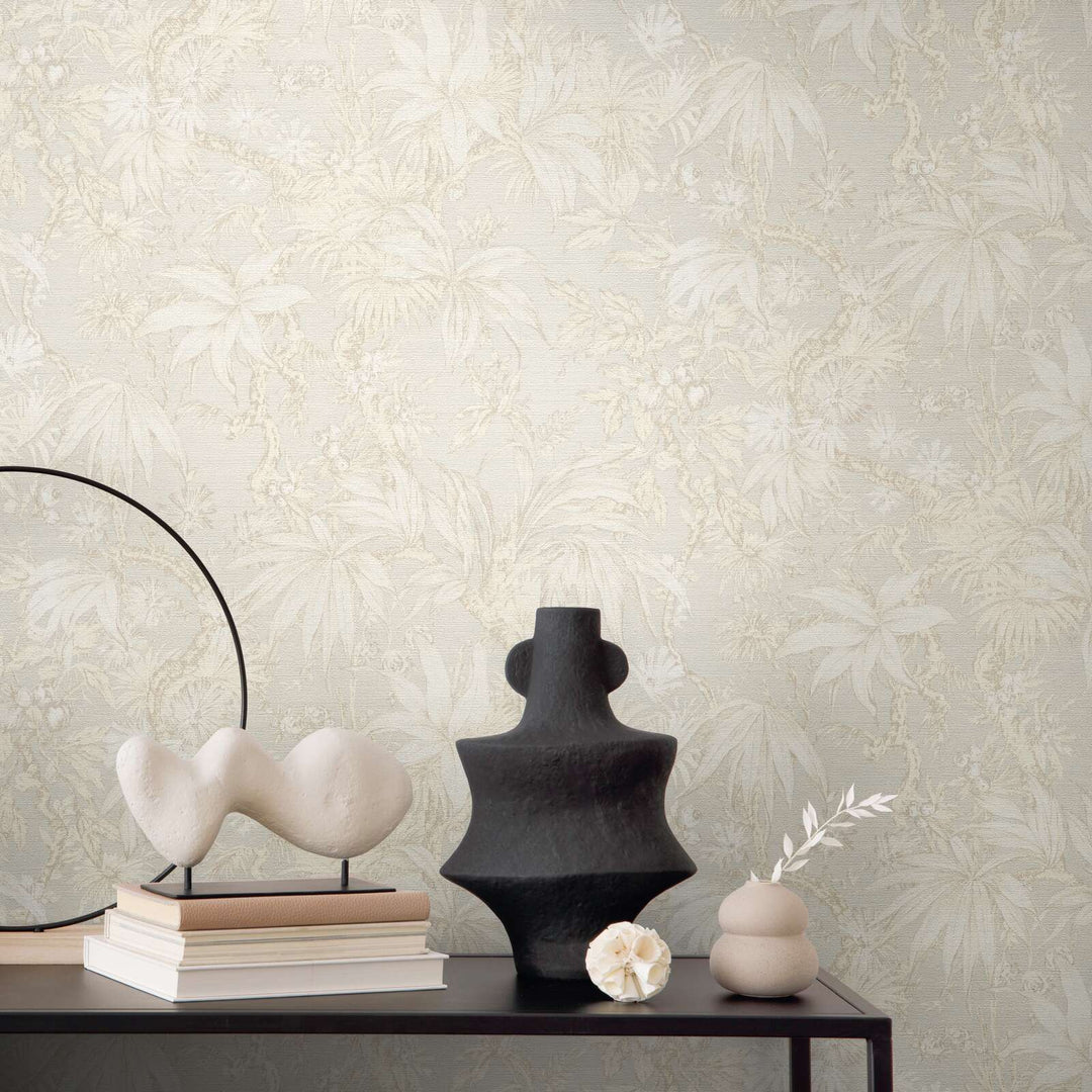 Light beige botanical pattern wallpaper in an interior behind a black table with decorative vases and sculptures