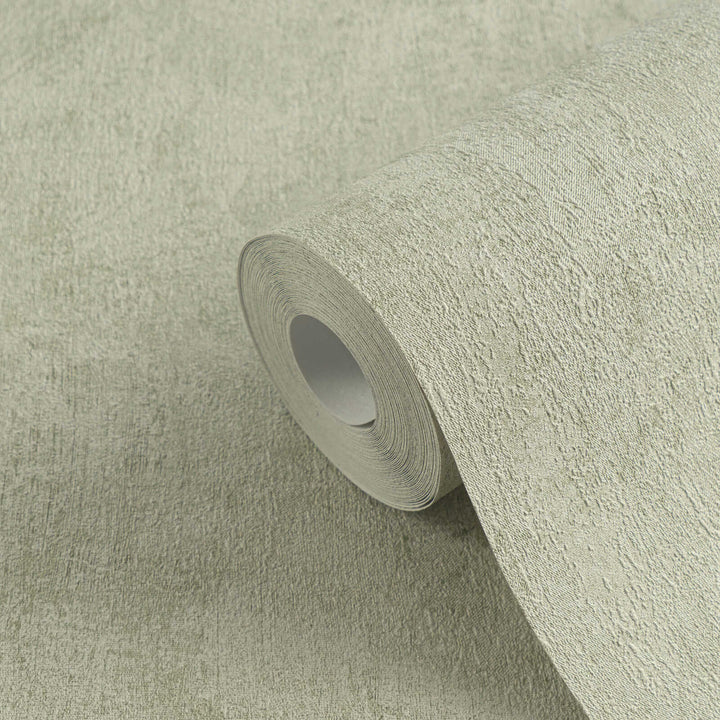 Roll of light greenish-gray textured wallpaper in close-up