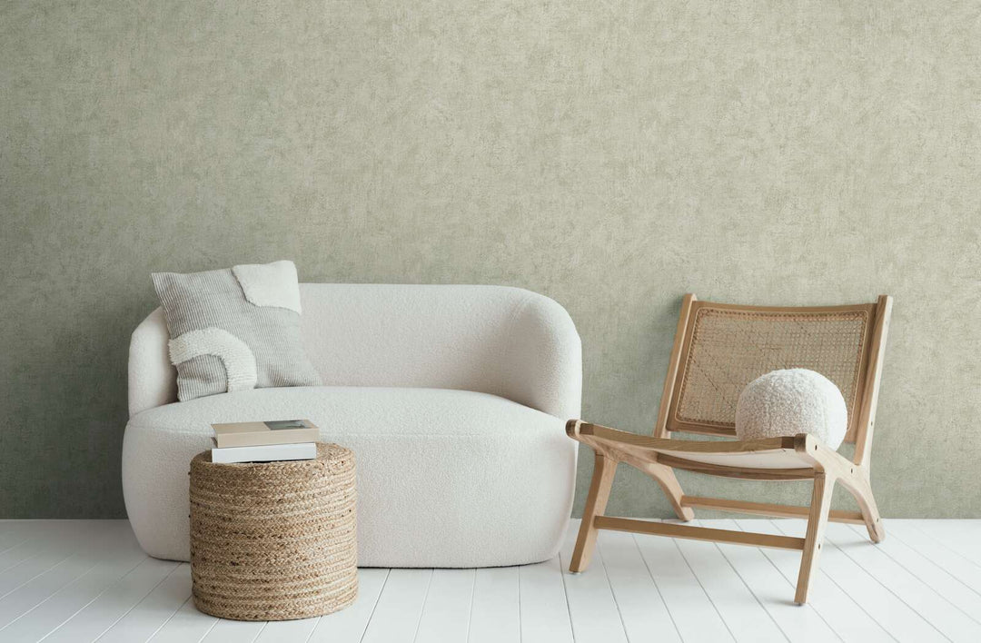 Light greenish-gray wallpaper in a modern living room interior with a white sofa and wooden lounge chair