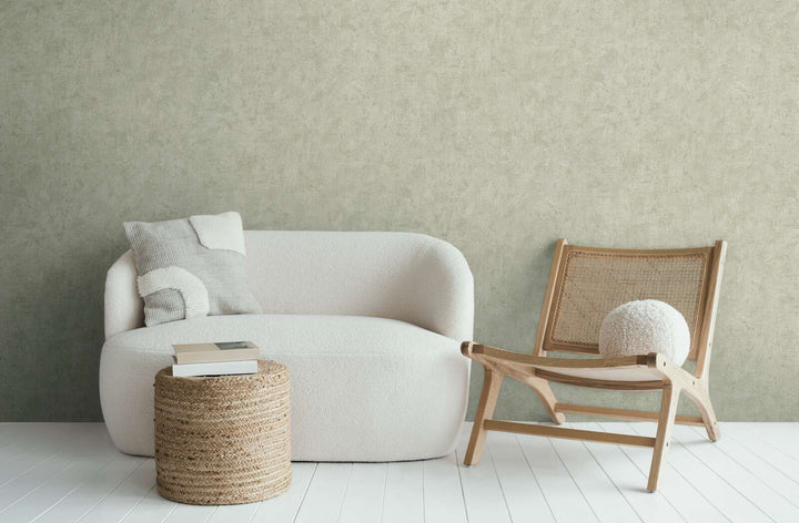 Light greenish-gray wallpaper in a modern living room interior with a white sofa and wooden lounge chair