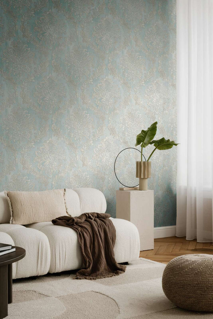 Light blue damask pattern wallpaper in a living room interior with a white sofa and natural wood parquet flooring with a light rug