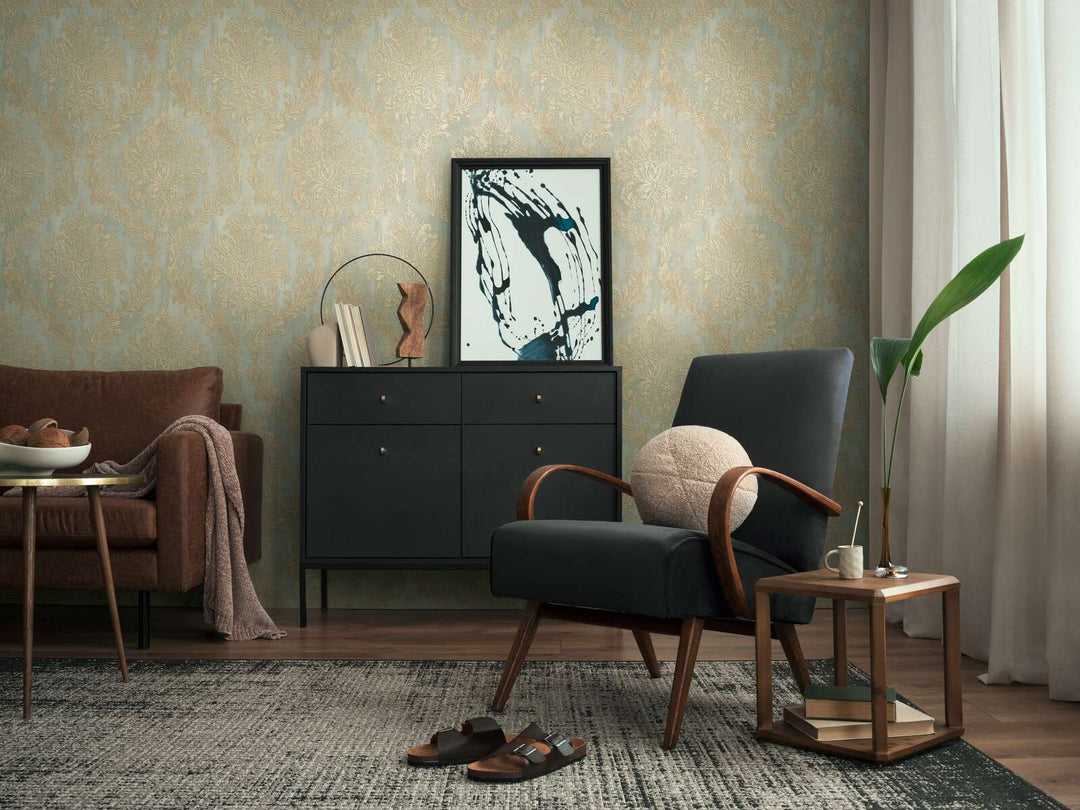 Light greenish damask pattern wallpaper in a living room interior with a black lounge chair, black dresser, and brown wood floor with a rug