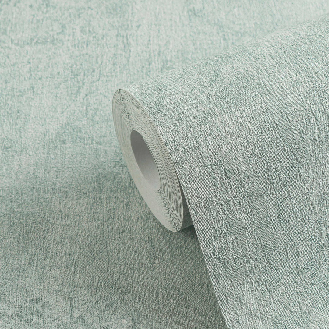 Roll of light bluish-gray textured wallpaper in close-up