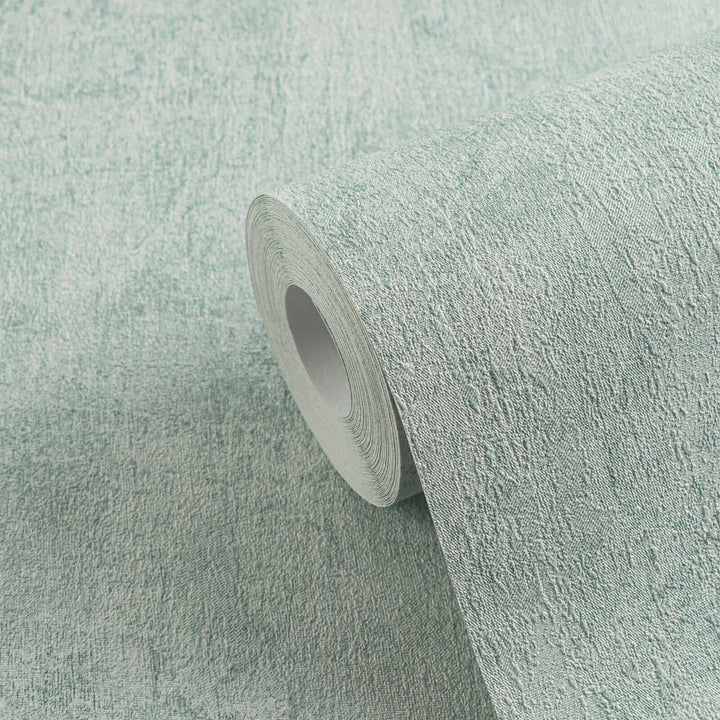 Roll of light bluish-gray textured wallpaper in close-up