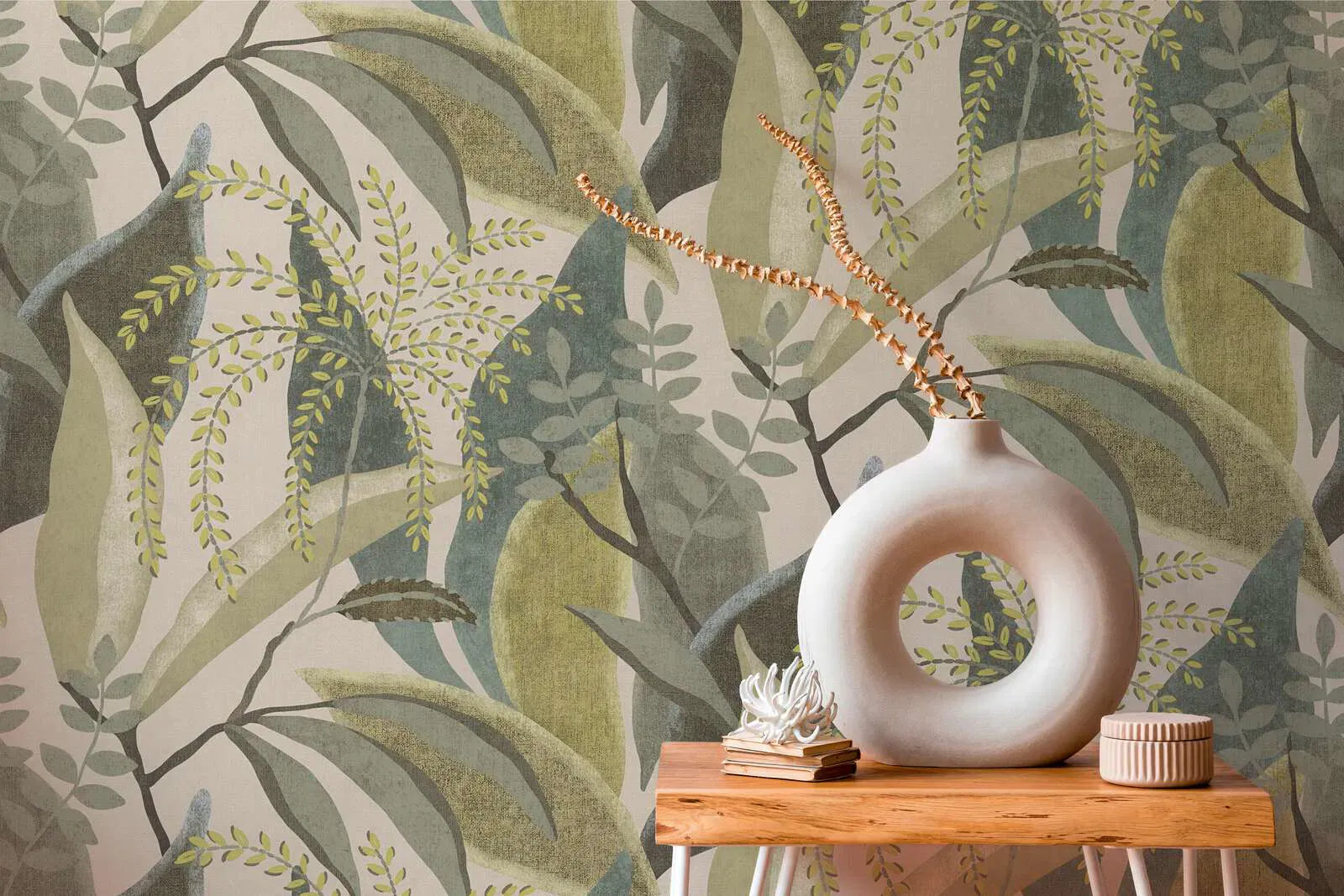 Green leaves wallpaper on a cream background in a natural living room interior. SKU: 3012470, AS Creation.